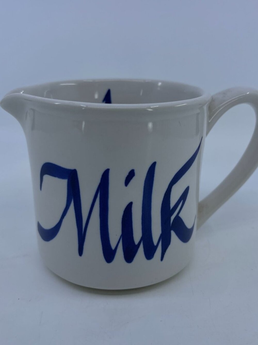 vintage white ceramic milk pitcher with blue script design & spout 1993